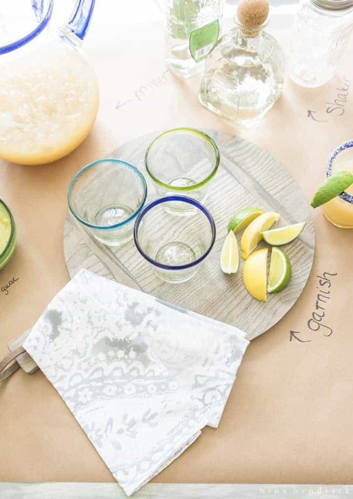 Garnishes, glasses, and a Mexican tile napkin for Cinco de Mayo