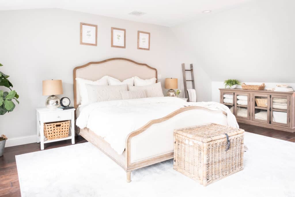 Bedroom with nickel and black accents plus light colored linens.