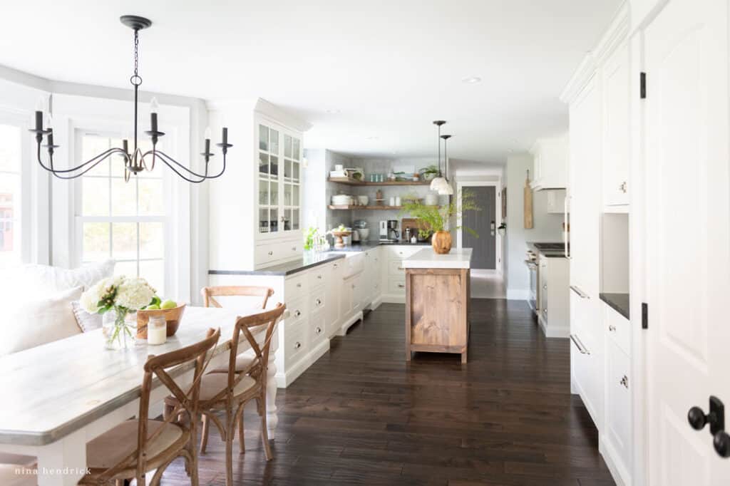 Kitchen with black door knobs and light fixtures and polished nickel cabinet hardware.