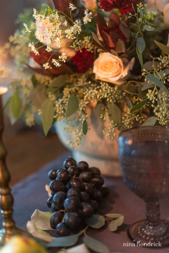 grapes next to floral arrangement