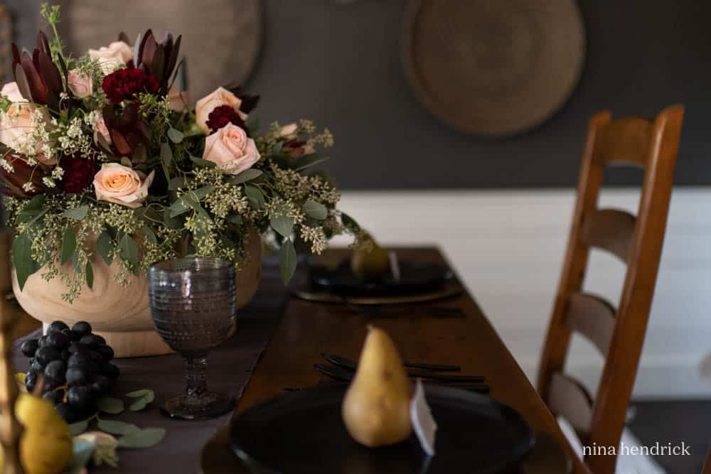 Rose floral arrangement with dark plates
