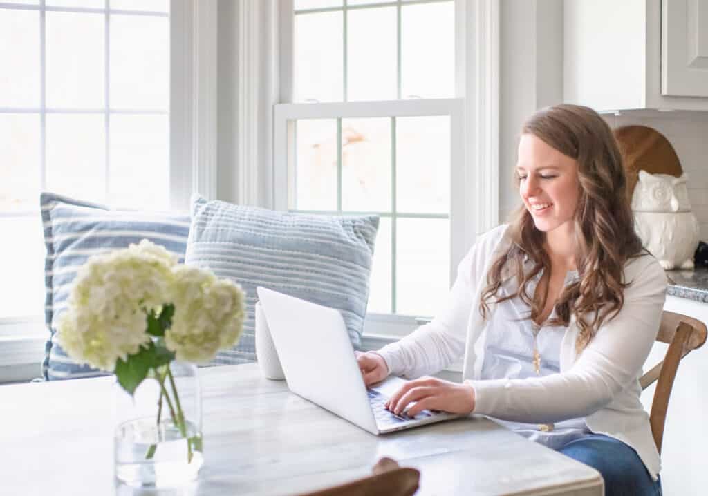 Nina Hendrick working on laptop in breakfast nook as part of her morning routine.