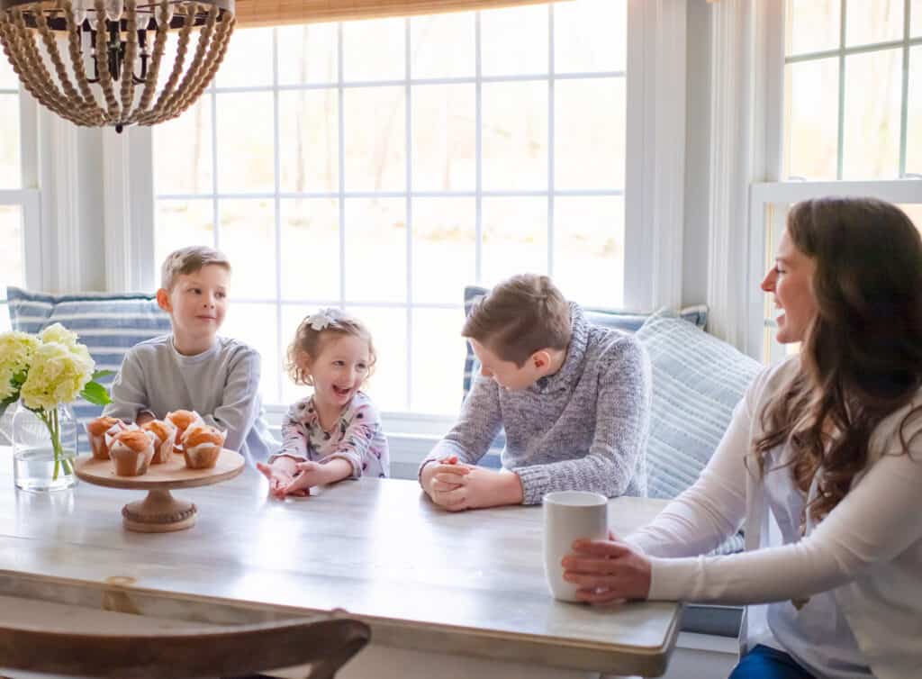 Family eating breakfast around a table as part of their morning routine