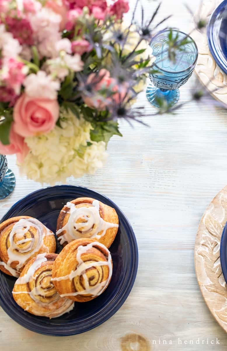 Flowers and cinnamon buns at a mother's day brunch
