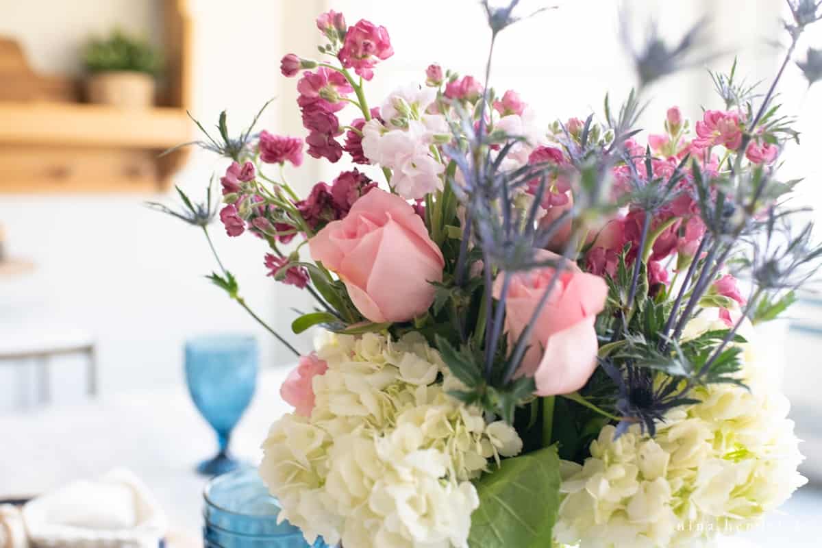 floral arrangement with roses, hydrangea, and sweet peas