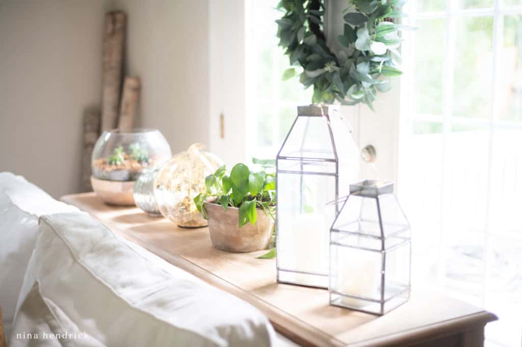 subtle fall decor with lanterns and a pumpkin