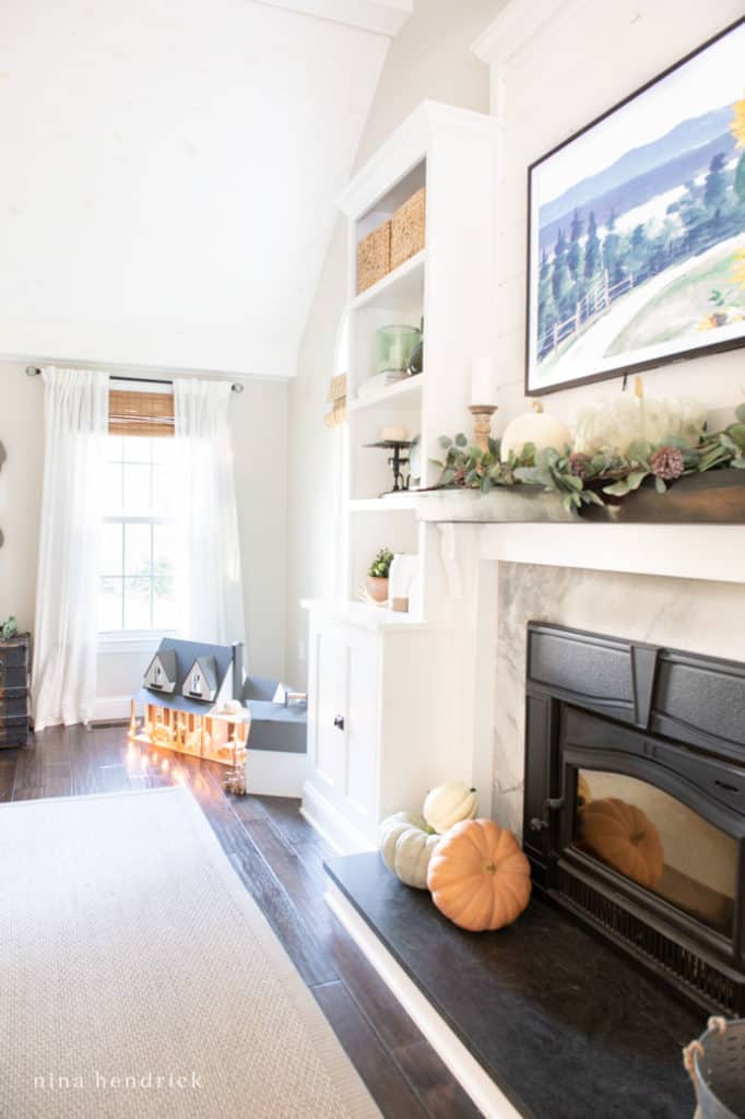 Muted fall heirloom pumpkin decor in the family room around the built-ins