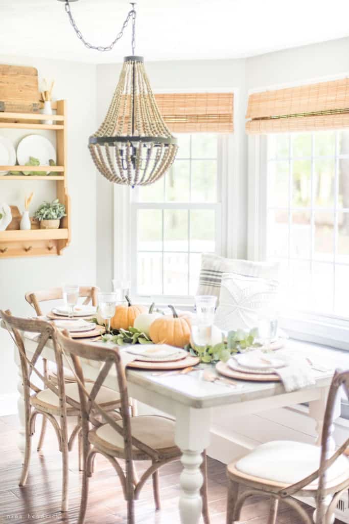 dining room decorated with muted fall colors with a built-in bench