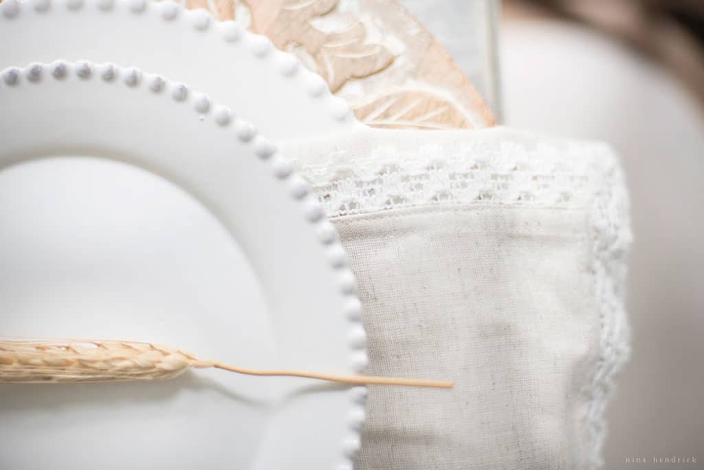 Close up of neutral fall place setting with white plates