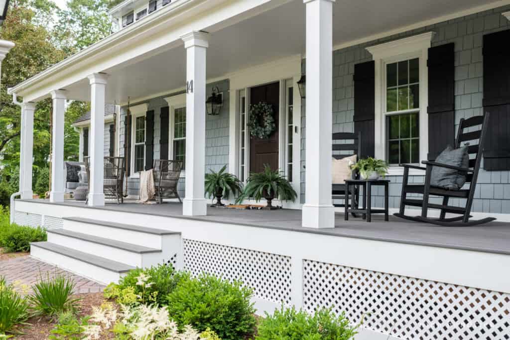 Porch with white columns and lattice in front of the garden