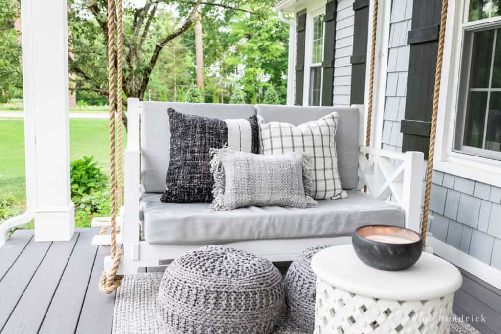 farmer's porch swing with outdoor pillows