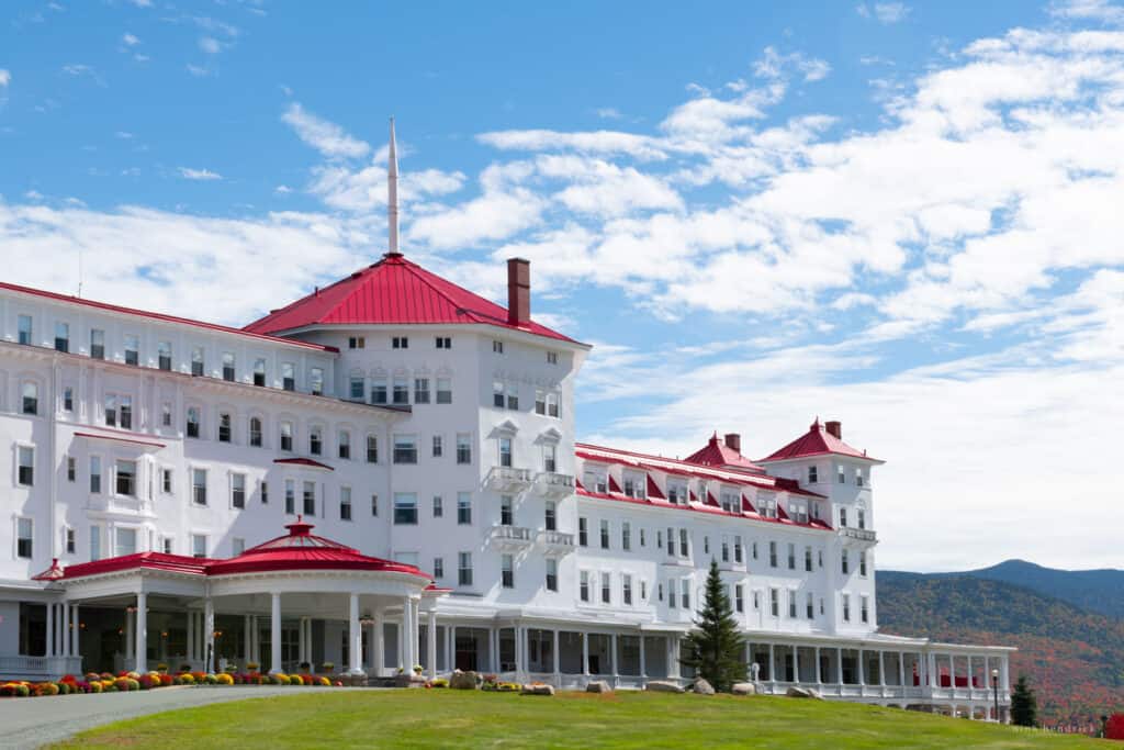 The Omni Mount Washington, a large white building with a red roof in a grassy field