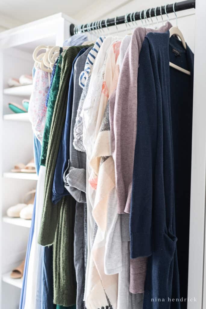 clothes hanging in an organized closet