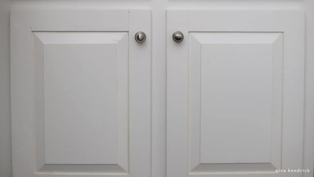 close up of water damaged painted oak cabinet doors