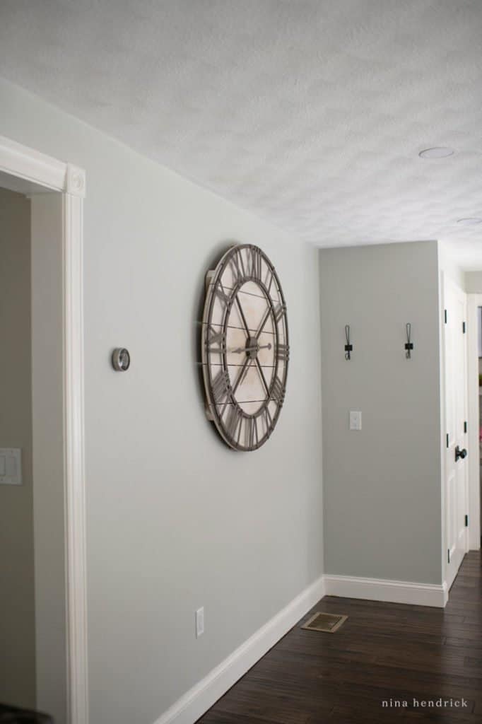 giant clock on blank wall unused kitchen space