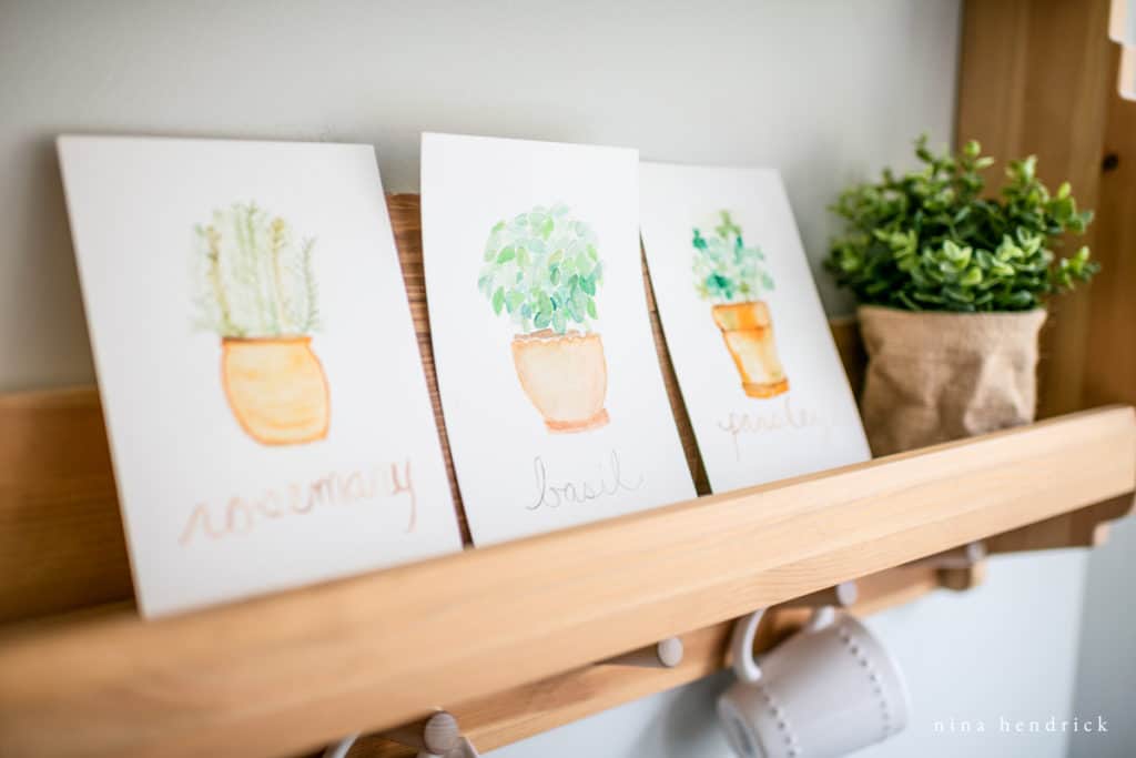 Potted Herb Watercolor Prints on a kitchen shelf