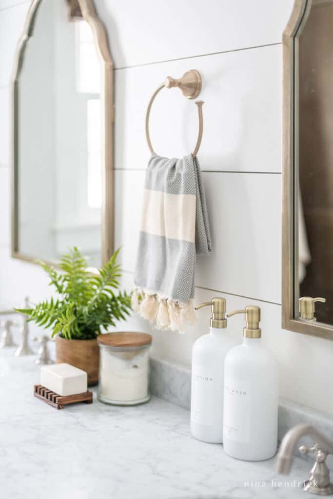 Soap and towel on a towel ring above a bathroom vanity