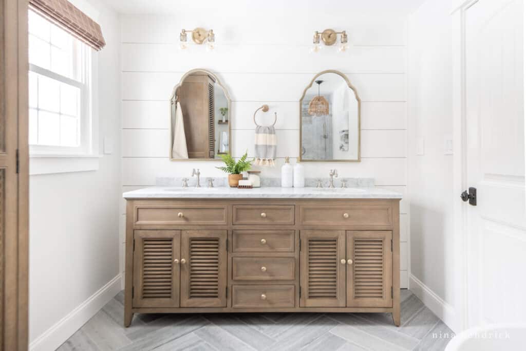 Primary bathroom remodel with herringbone floors and planked walls 