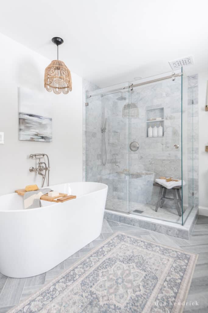 Primary bathroom renovation with a freestanding tub and glass shower surround with Benjamin Moore Paper White walls