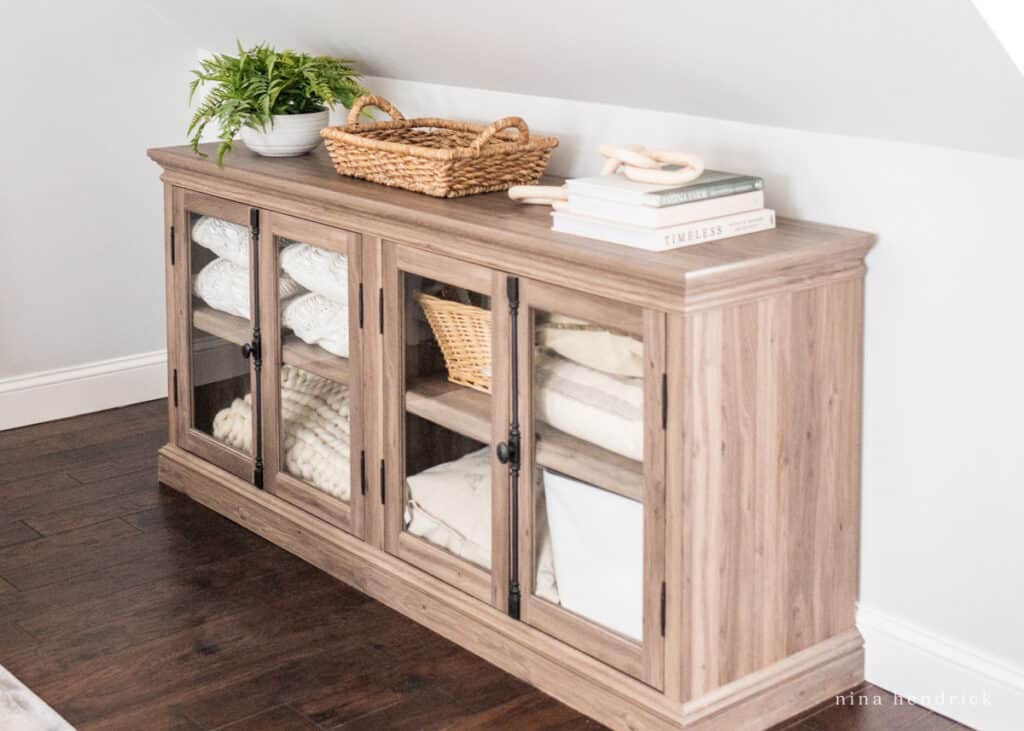 Storage solution for a sloping roof during a primary bedroom makeover: linen cabinet