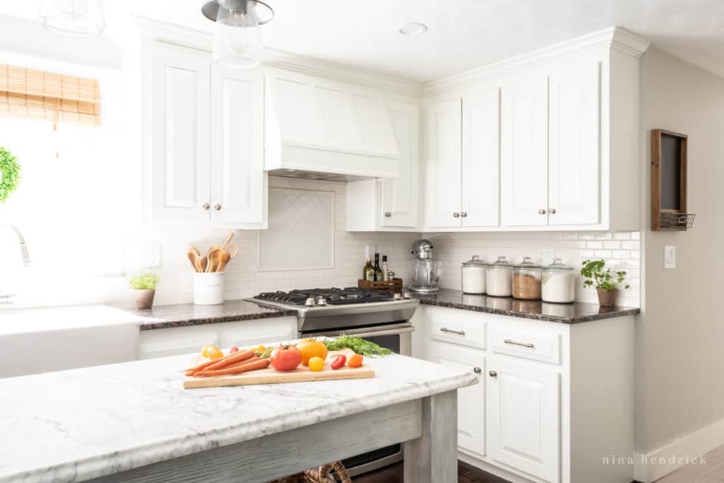 Kitchen with white painted cabinets and a DIY range hood cover