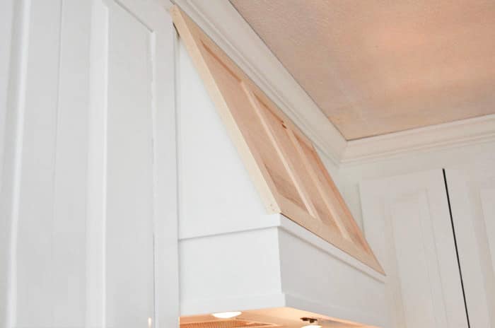 Fill in any nail holes and sand your new range hood cover