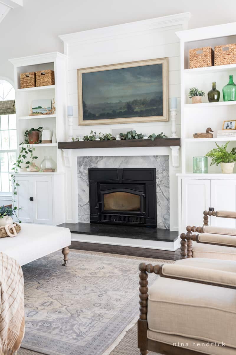 Living room with layered area rugs, one in a custom sisal size, and one 6x9 hand-knotted.