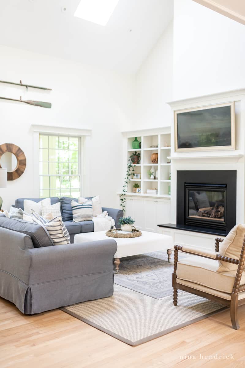 Family room with hand-knotted rug over sisal and cotton area rug