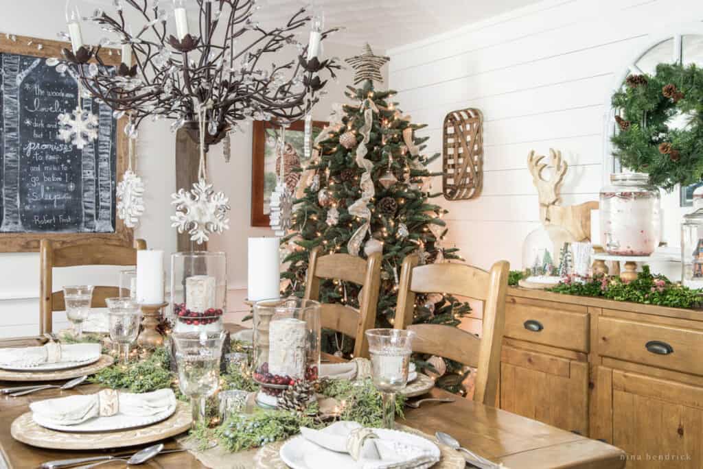 Rustic Christmas tablescape in the dining room with raw wood and a tree. 