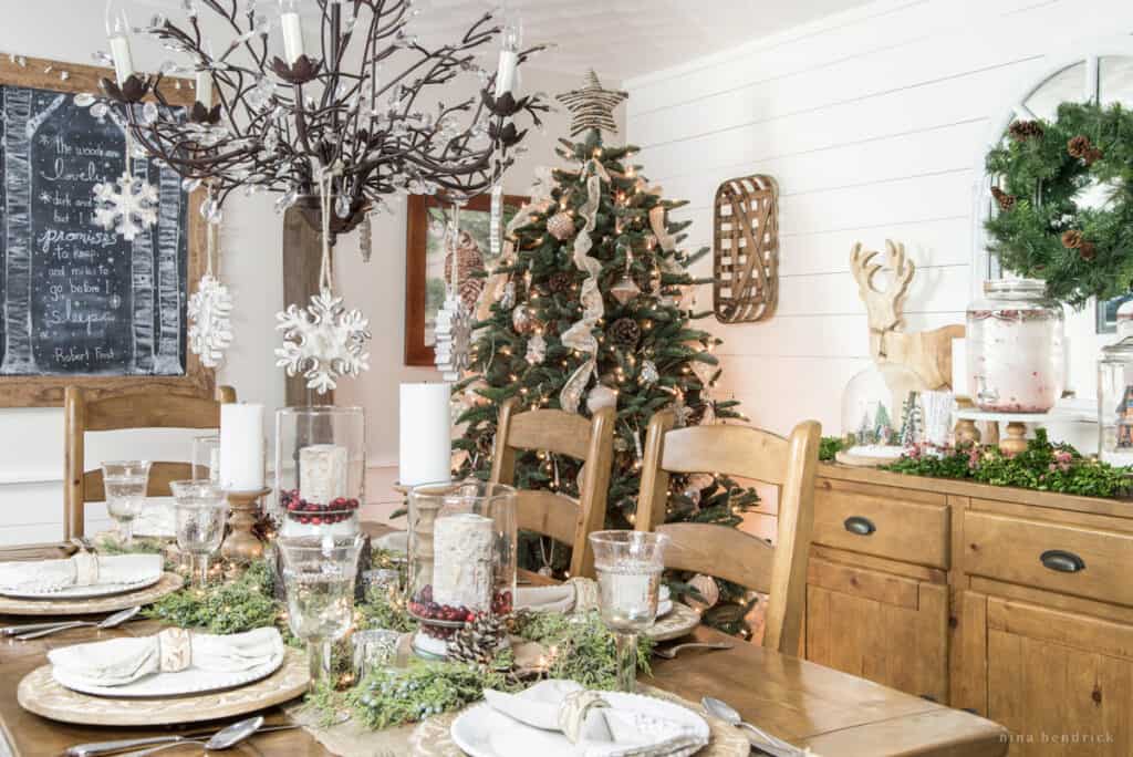 Rustic Christmas tablescape in the dining room with raw wood and a tree.