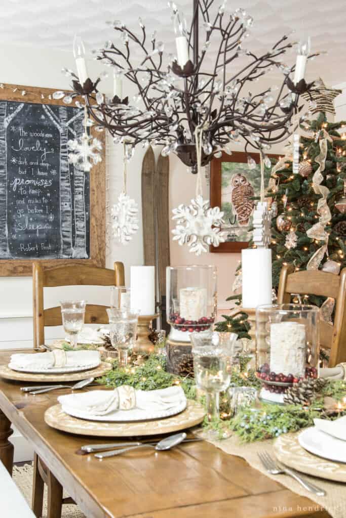 Rustic Christmas Decorating Ideas for all over your home — starting in the dining room with glass hurricanes with cranberries and epsom salt.