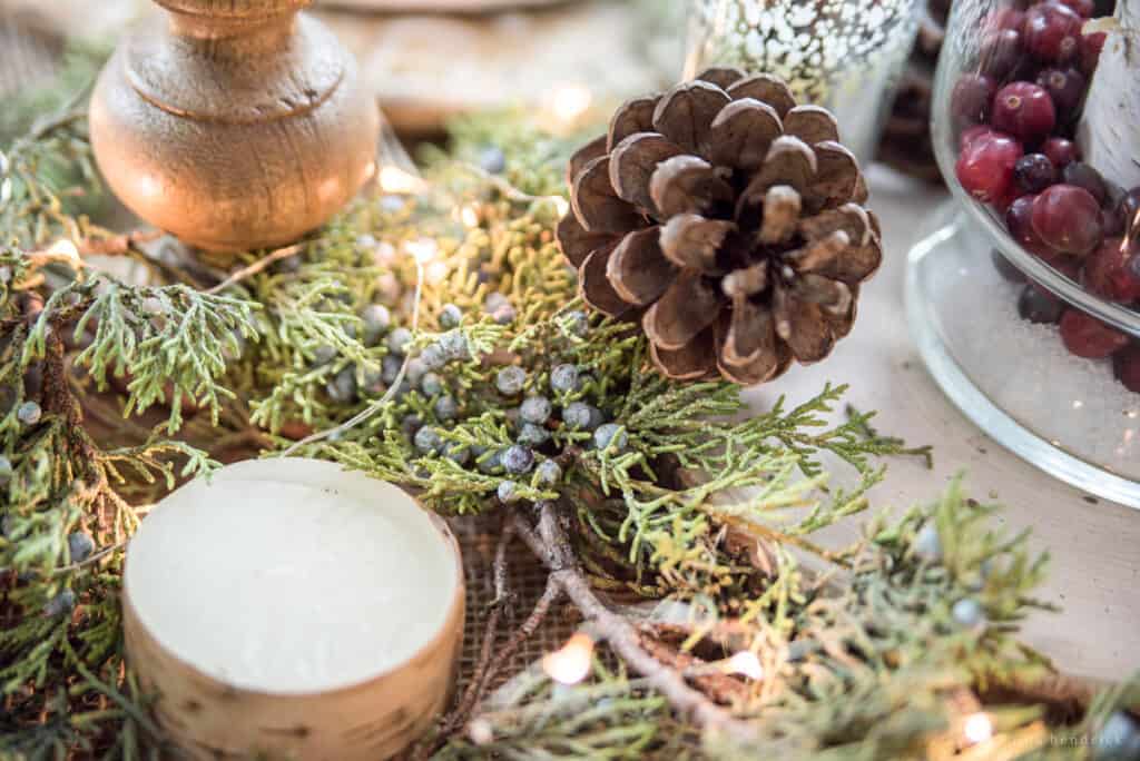 Juniper garland centerpiece with pinecones and birch candles