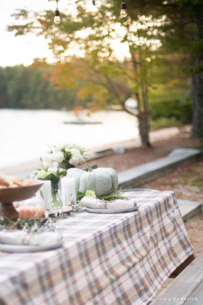 Autumn tablescape by the lake with heirloom pumpkins and fall colors.