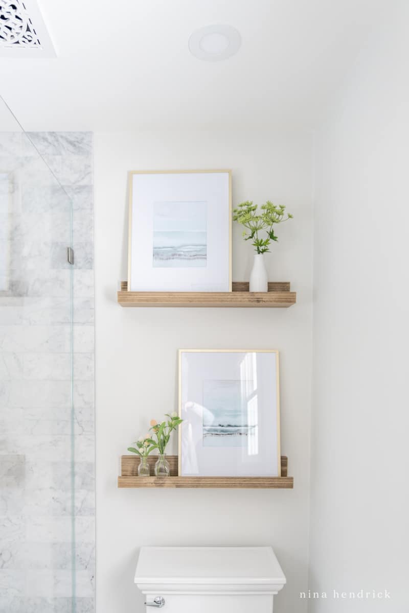 Floating shelves in the bathroom to display minimalist decor