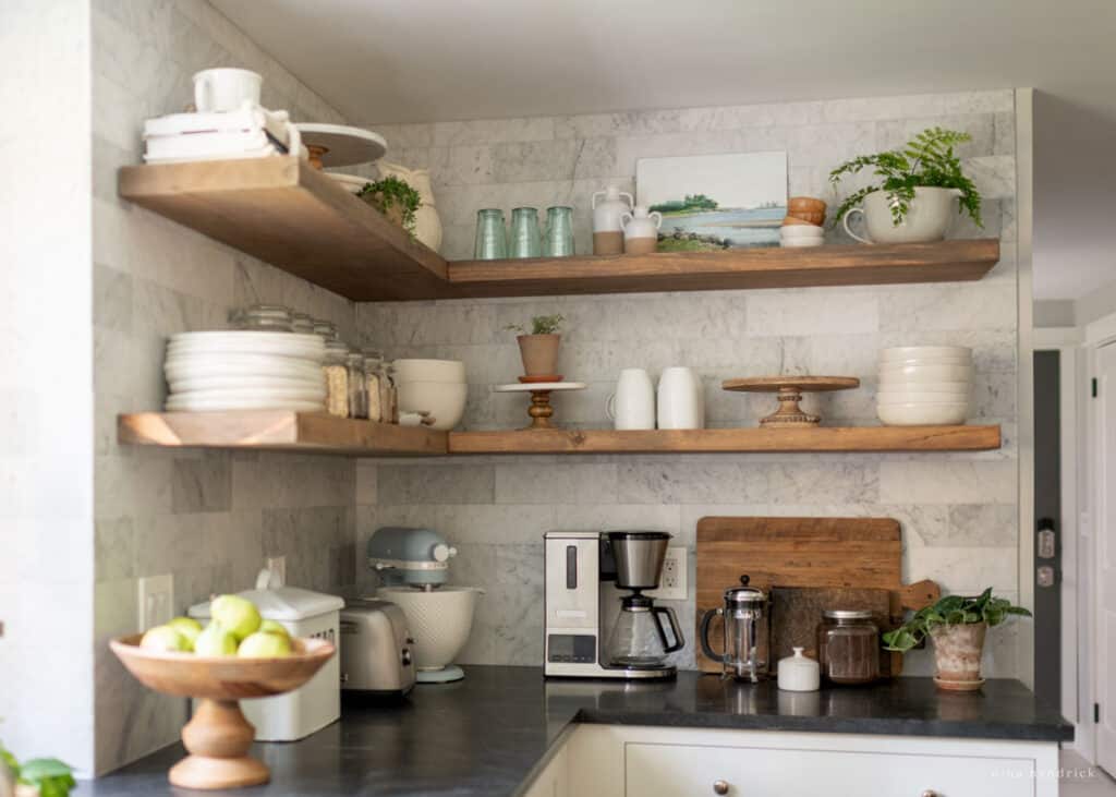 Shelf decor ideas in the kitchen with neutral plates and pottery dishes