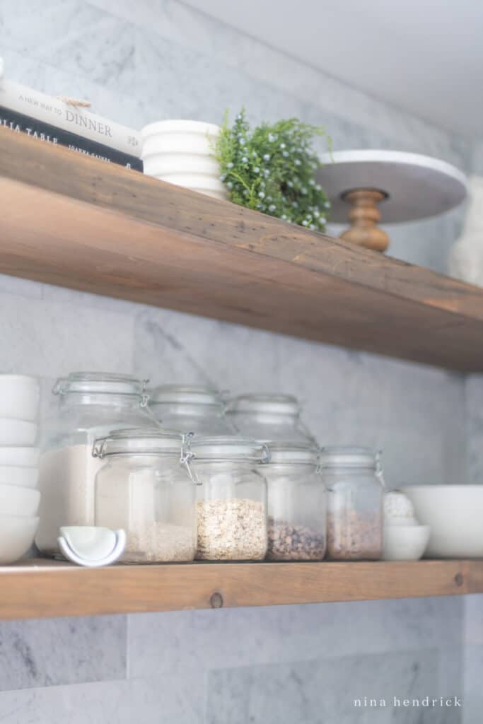 jars on a shelf holding dry goods