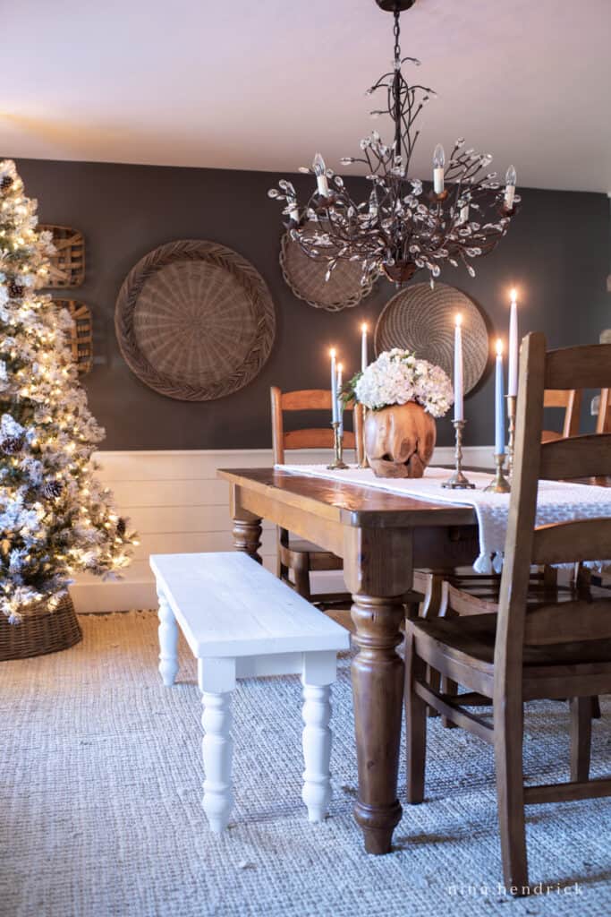 Dining room table with glowing blue candles and Christmas tree