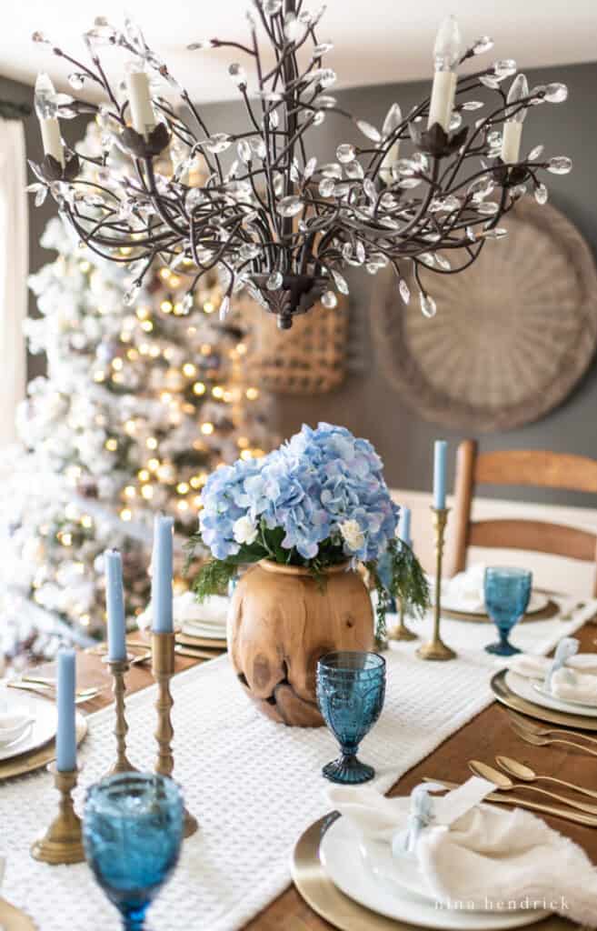 Simple Blue Christmas Tablescape with a hydrangea centerpiece and colbalt blue glasses