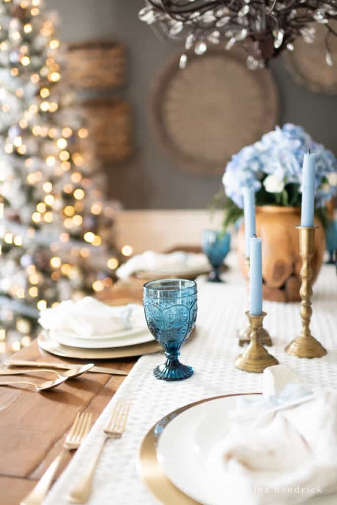 candles and glassware with a tree and lights