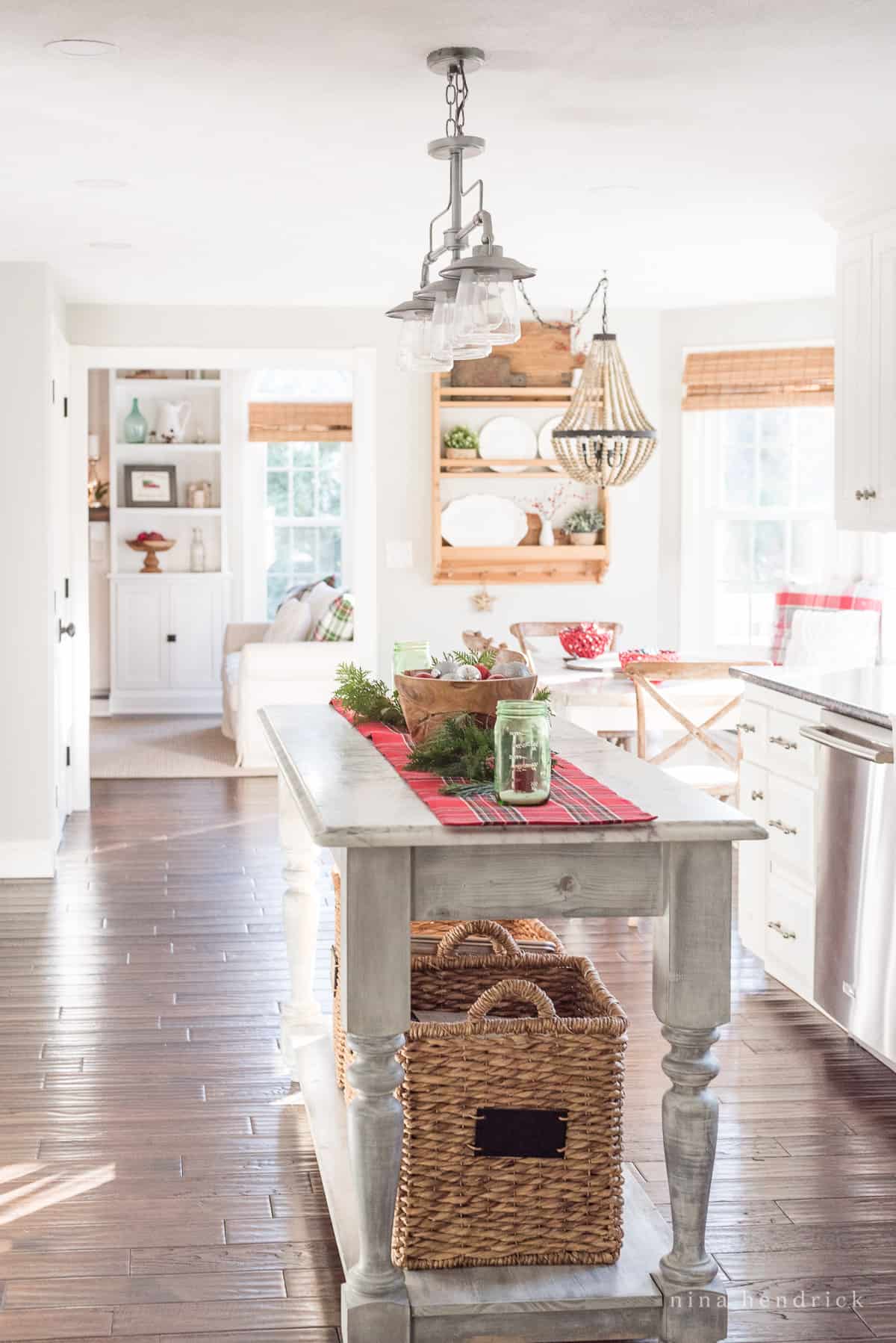 Simple Christmas decor in the kitchen with a rustic wooden island and dark floor