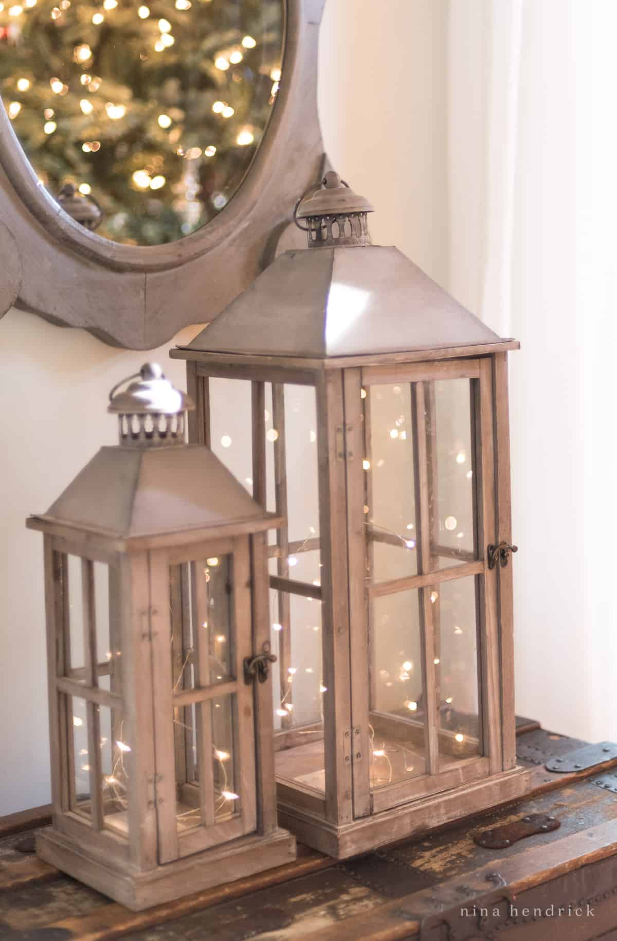 Rustic Lanterns with LED lights sparkling inside in front of a mirror