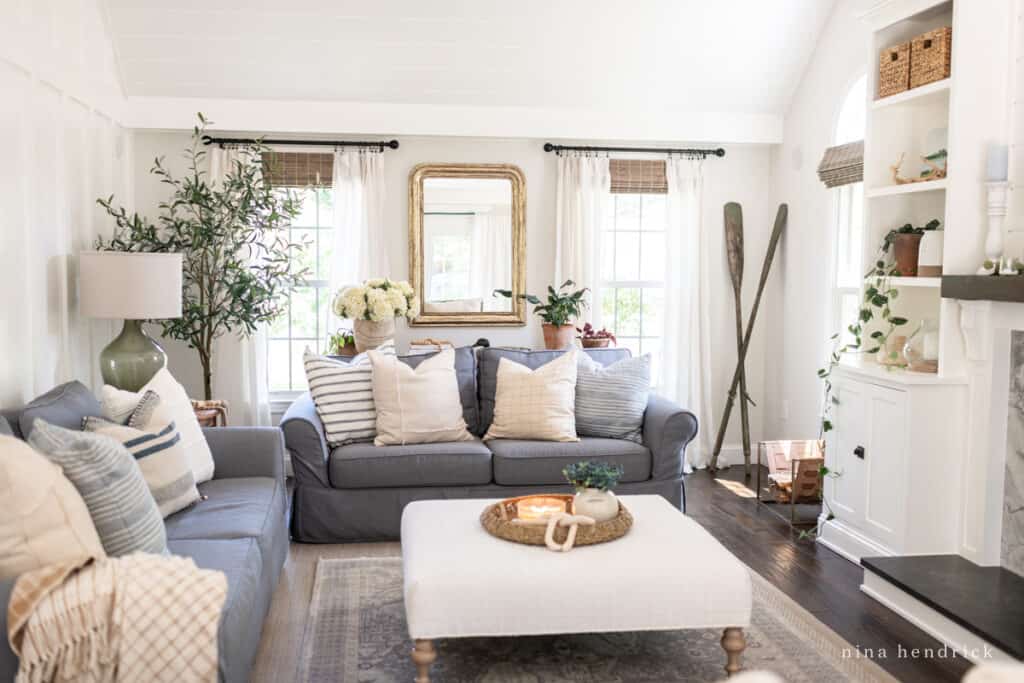 Living room with gray slipcovered sofas and bright sunny windows