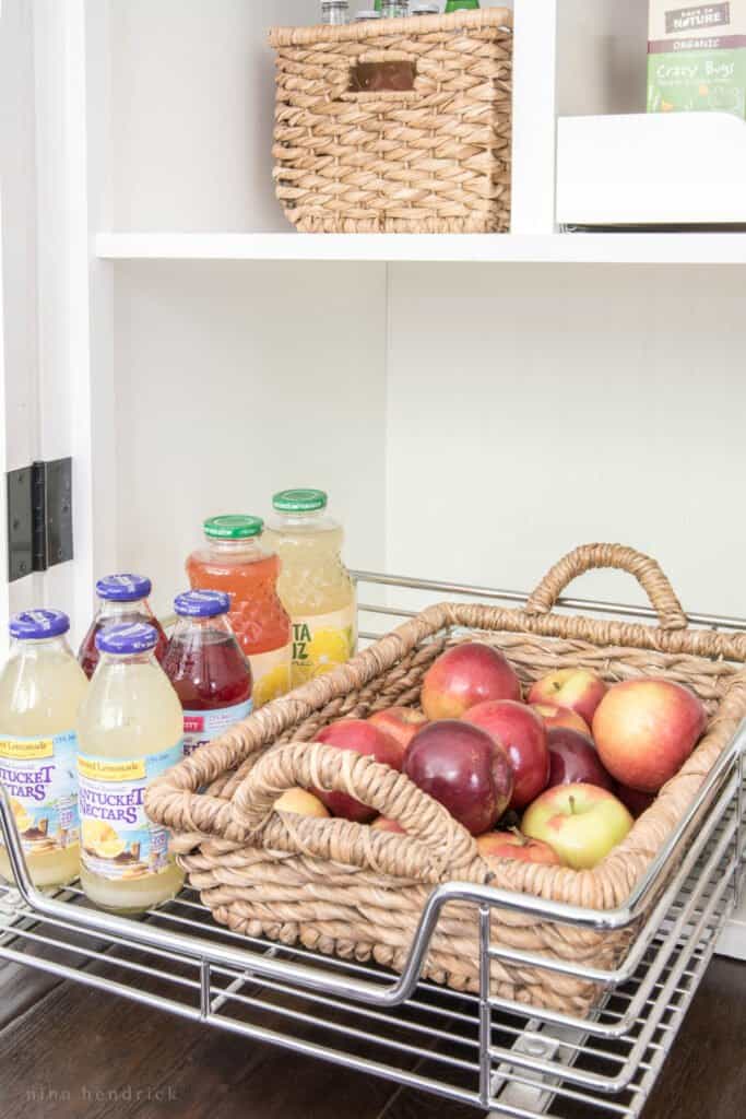 Slide out pantry shelf storage with basket for fruit