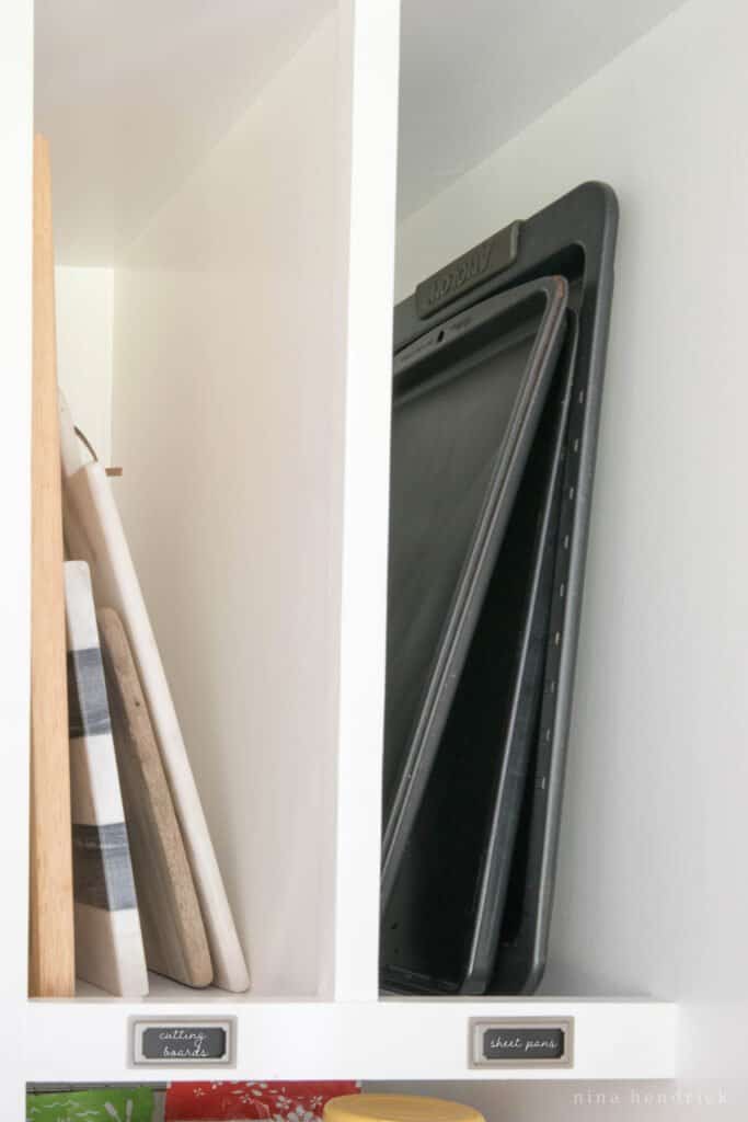 Divided storage in the pantry for cutting boards and cookie sheets