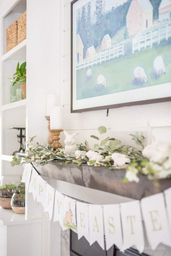 Spring decorating ideas for the mantel with wooden candle holders and bunny statues