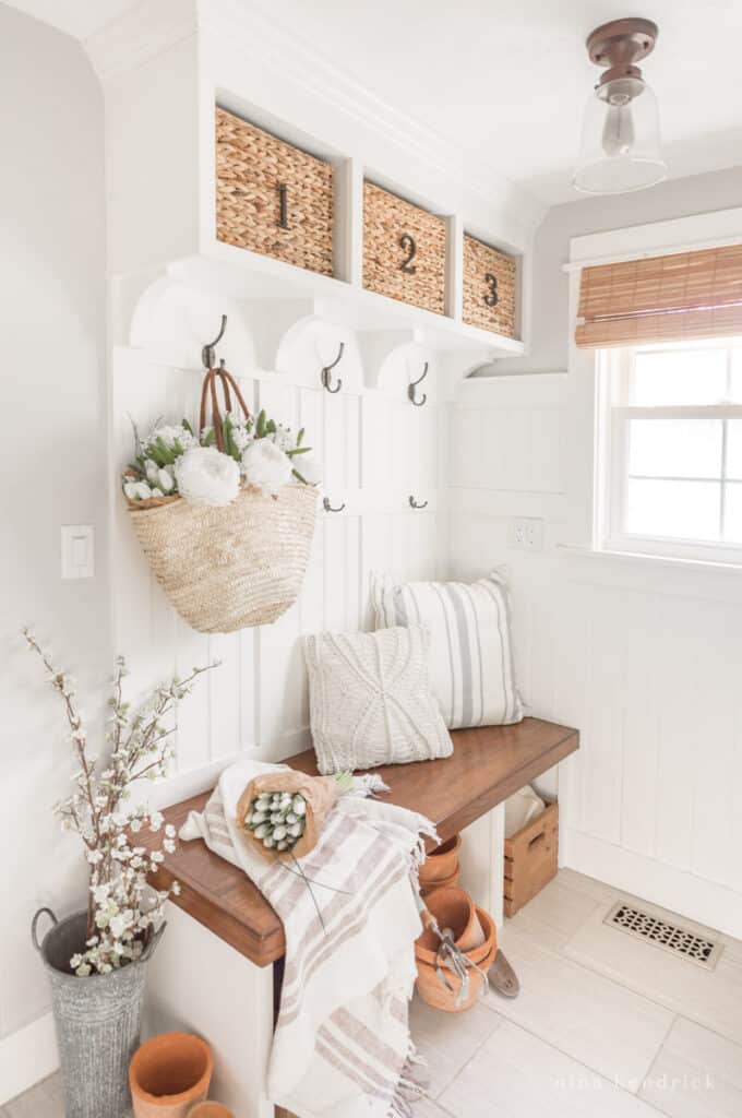 Spring Decorating Ideas in a mudroom with flowers and baskets