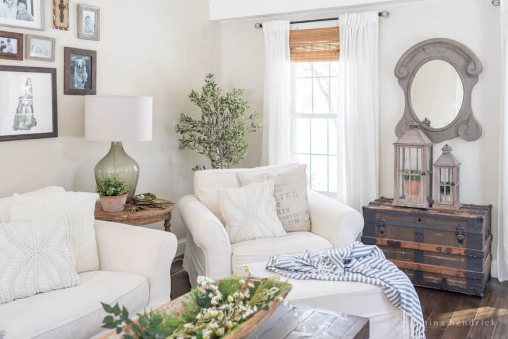 How to decorate for spring in the family room — greenery and branches with white sofas