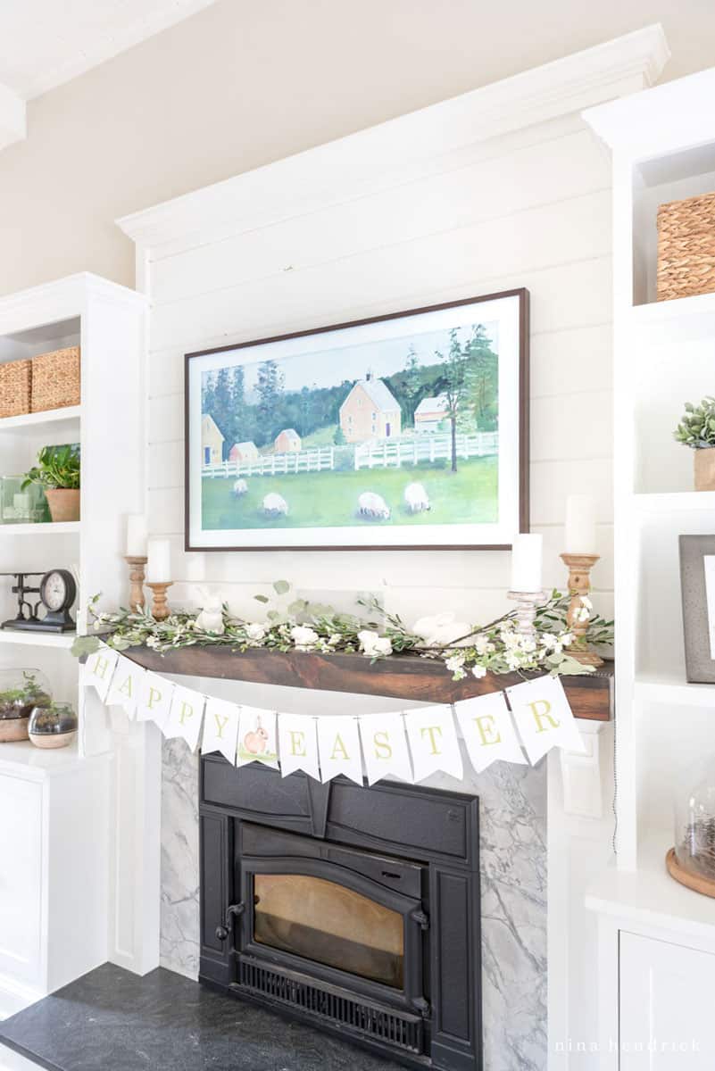 Spring mantel decor with ideas including "Happy Easter" banner and Frame TV with pastoral artwork