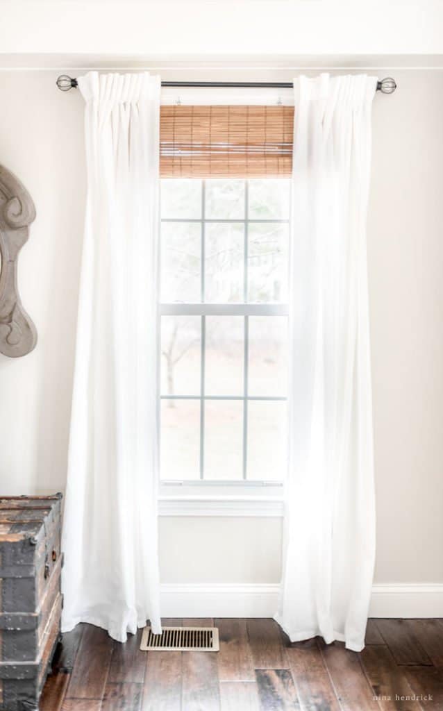 light white window treatments hanging in white room