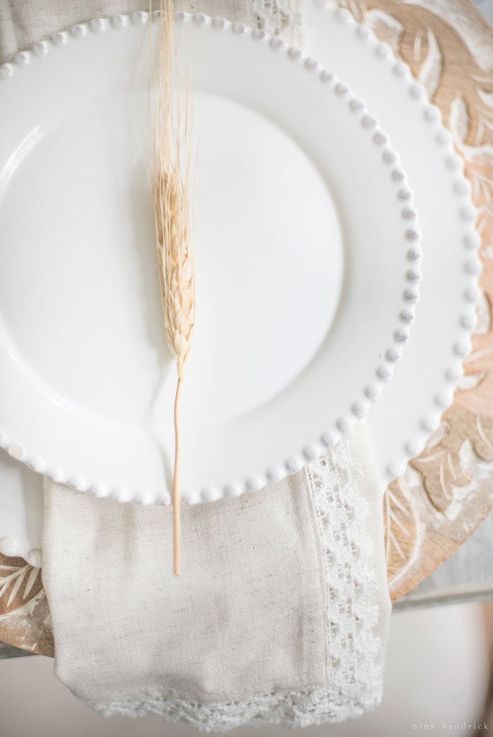 A white plate with a wheat stalk on it.